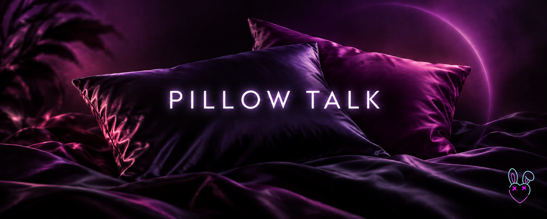Purple satin pillows with Pillow Talk text and PLZ KEEP CUMING neon bunny-heart logo